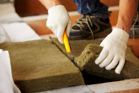 male carpenter is working with wooden plankの写真素材