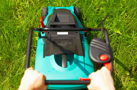 Mowing the lawn with new modern mower
