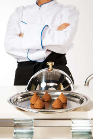 happy smiling caucasian female chef introducing new dishの写真素材