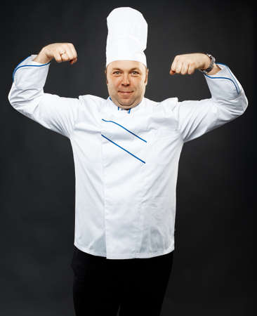 mature caucasian male chef over grey background