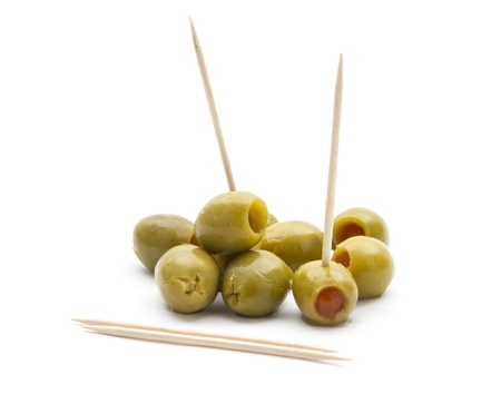 green olives with toothpick isolated on white backgroundの写真素材