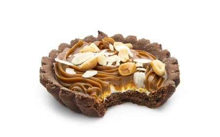 bitten chocolate tart with caramel isolated on white backgroundの写真素材