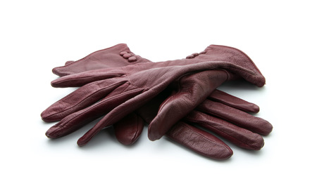 pair of old gloves isolated on white backgroundの写真素材