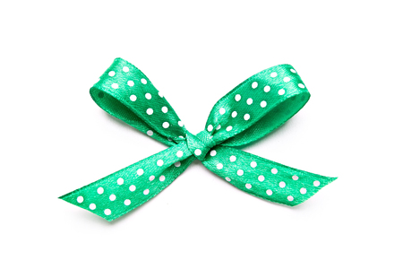 green bow with dots isolated on white backgroundの写真素材