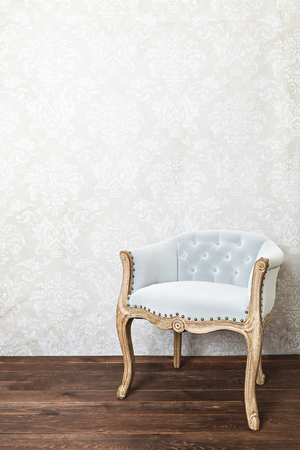 retro armchair on wallpaper background, wooden floor, copy spaceの写真素材