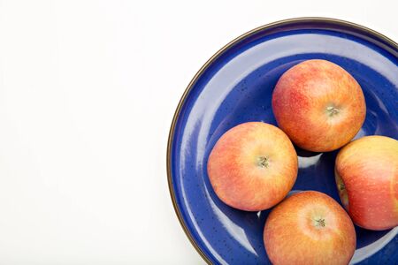 part of blue plate with apples, top viewの写真素材