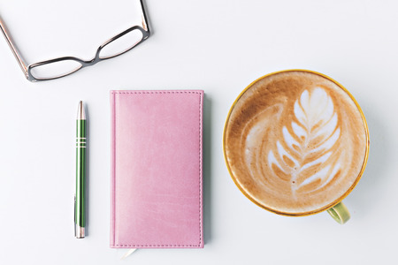 closed notebook with pen and coffee, flat layの写真素材