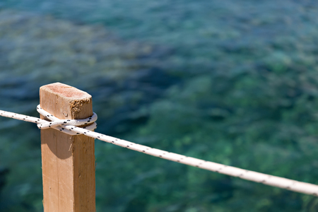 closeup of rope at the wooden poleの写真素材
