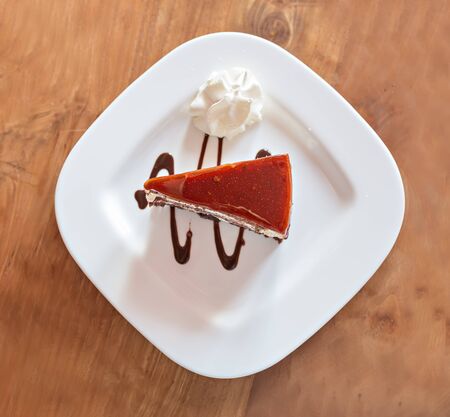 cake on white plate on the wooden backgroundの写真素材