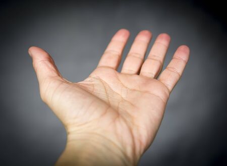 opened empty hand on gray background