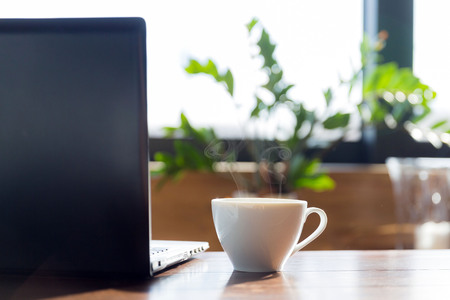 opened notebook and coffee on the table