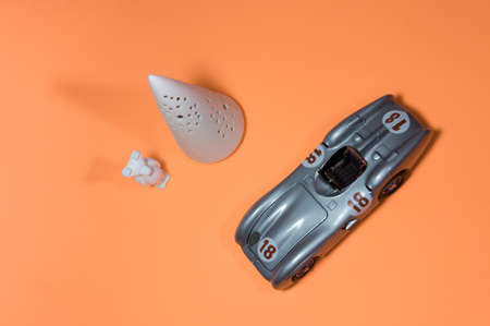 Toy cars and objects placed on orange paper.の写真素材