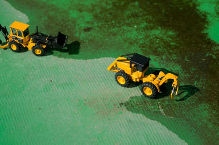 Two forklifts, put into the green zone construction upstream of the river.の写真素材