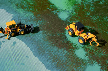 Two forklifts, put into the green zone construction upstream of the   river.の写真素材