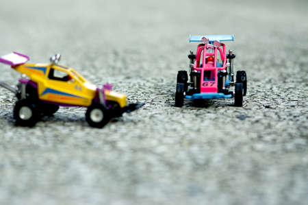 A small off road toy car for 1 person is on the cement floor.の写真素材