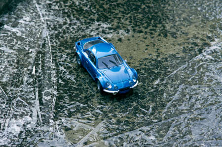 A blue toy car standing on ice.の写真素材