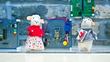 Sheep model standing in front of computer accessories.の写真素材