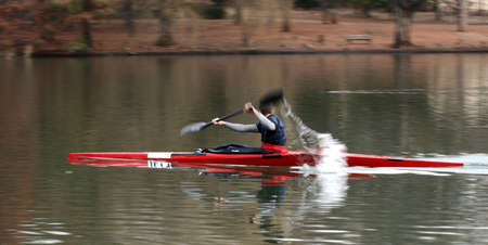 Kayak on the pond with splashing paddles