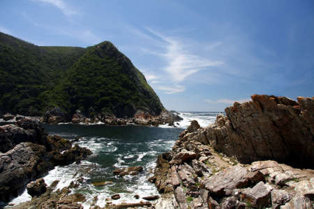 Rugged coastline with sea, rocks and blue skyの写真素材