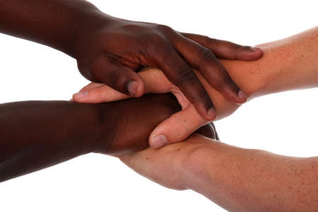 Hands of black and white males clasped togetherの写真素材