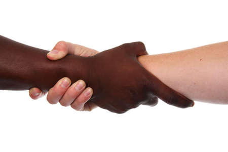 Two hands, black and white, in a strong claspの写真素材