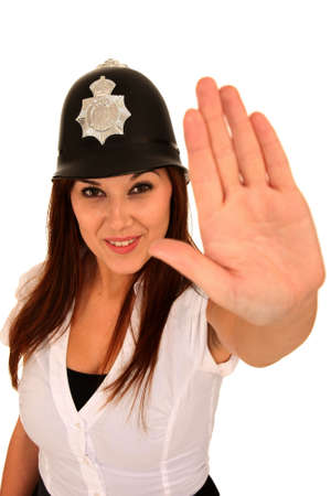 Beautiful brunette woman wearing a toy police hat and hand out in stop signの写真素材