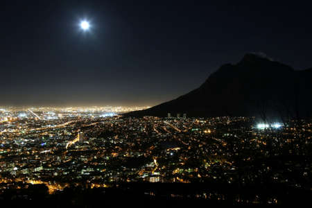 Cape Town city at night with moon in the skyの写真素材