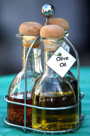 Olive oil in a glass bottle with wooden stopper