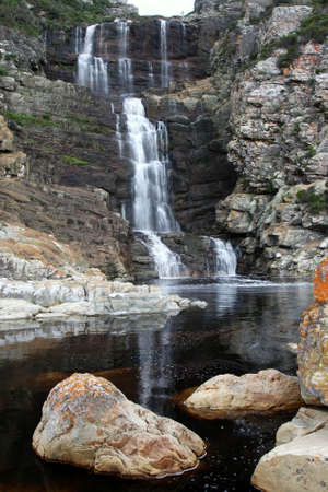 Beautiful waterfall cascading down rocks into a pool below