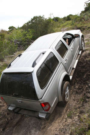 An offroad 4x4 vehicle negotiang a steep climb