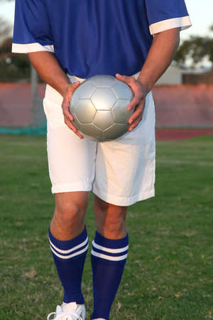 Soccer player about to kick the ball from handの写真素材