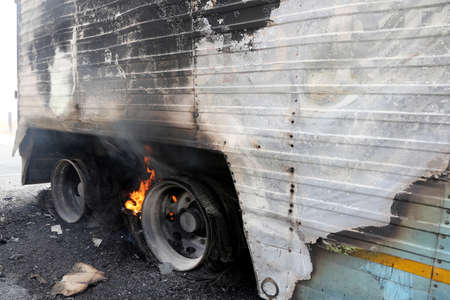 Truck trailor disastor with burning wheels from over heated brakesの写真素材