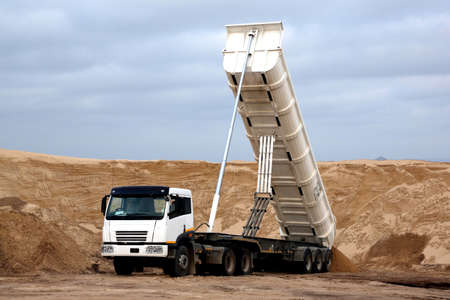 Huge tipper truck with hydraulic lifter in a sand quarryの写真素材
