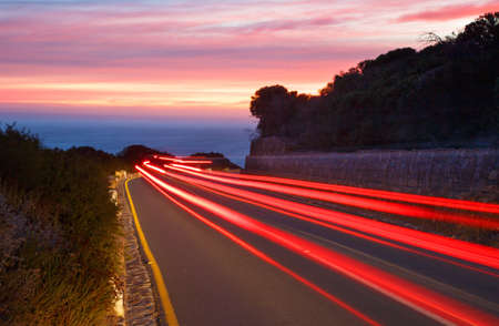 Light trails from passing cars at sunsetの写真素材