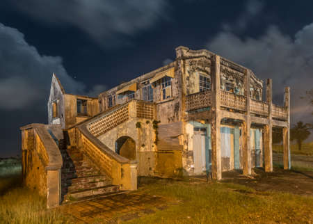 An eerie old delapidated and abandoned mansion in Barbados at night