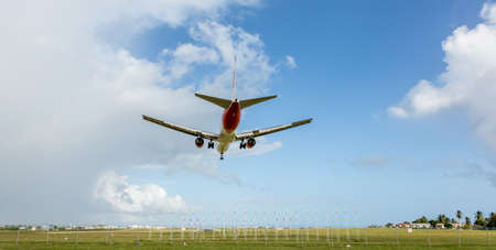 Jet aeroplane in blue sky coming in to land at an airport