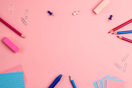 Pen, sticky note, notepad, marker, eraser, push pins, paper clip pencils on pink background. Flat lay top view. Education template back to school and online study concept with copy spaceの写真素材
