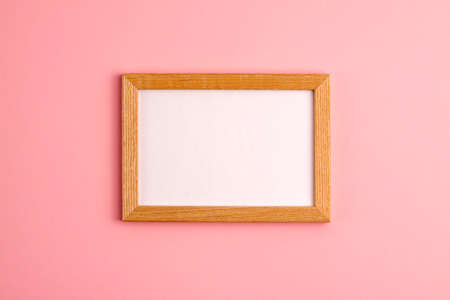 Mockup of wooden frame on pink background. Flat lay top view. Education template back to school and online study concept with copy spaceの写真素材