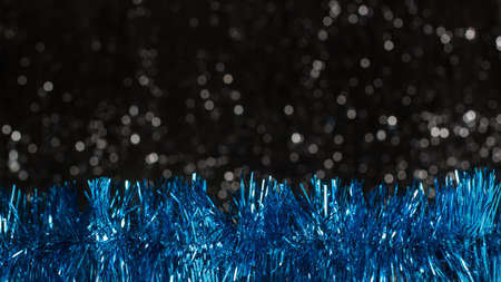 Christmas blue decorations on dark background with silver colors bokeh. Holiday concept with copy spaceの写真素材