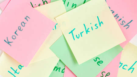 Top view flat lay of diferent languages english which written on the reminder notepaper of different colorsの写真素材