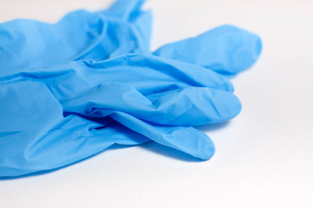 Medical glove on a blue background. hospital and health conceptの写真素材