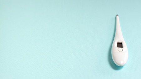 White thermometer at the right of the frame on a blue background with copy space.の写真素材