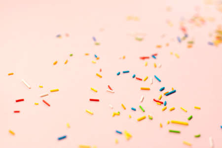 Colored sugar. Confectionery cooking concept with copy space on bright pink paper backgroundの写真素材