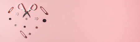 Small sewing set shaped heart on pink background with copy space. Flat lay top view. Design handicraft conceptの写真素材