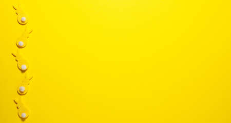 Yellow velvet bunnies on yellow background on the left with space for text. Flat lay top viewの写真素材