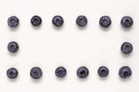 Macro shot blueberry aroun the frame on bright background from adobe. Food and vegetarian concept with copy spaceの写真素材