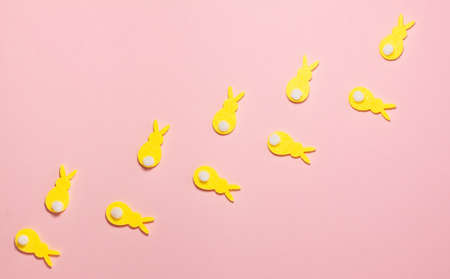 Yellow velvet bunnies on pink background with copy space. Flat lay top view. Easter conceptの写真素材