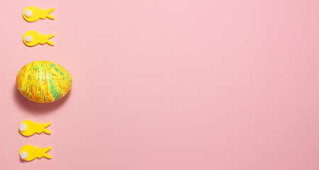 Yellow velvet bunnies and easter eggs on pink background on the left side with space for text. Flat lay top view. Easter conceptの写真素材
