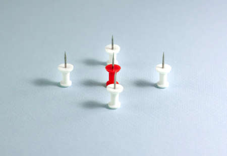 Coronavirus, COVID-19 concept and spread of infection. Red and white buttons pushpins on blue...