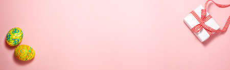 Banner template of Easter green and yellow eggs and white paper present box with red gift bow on...